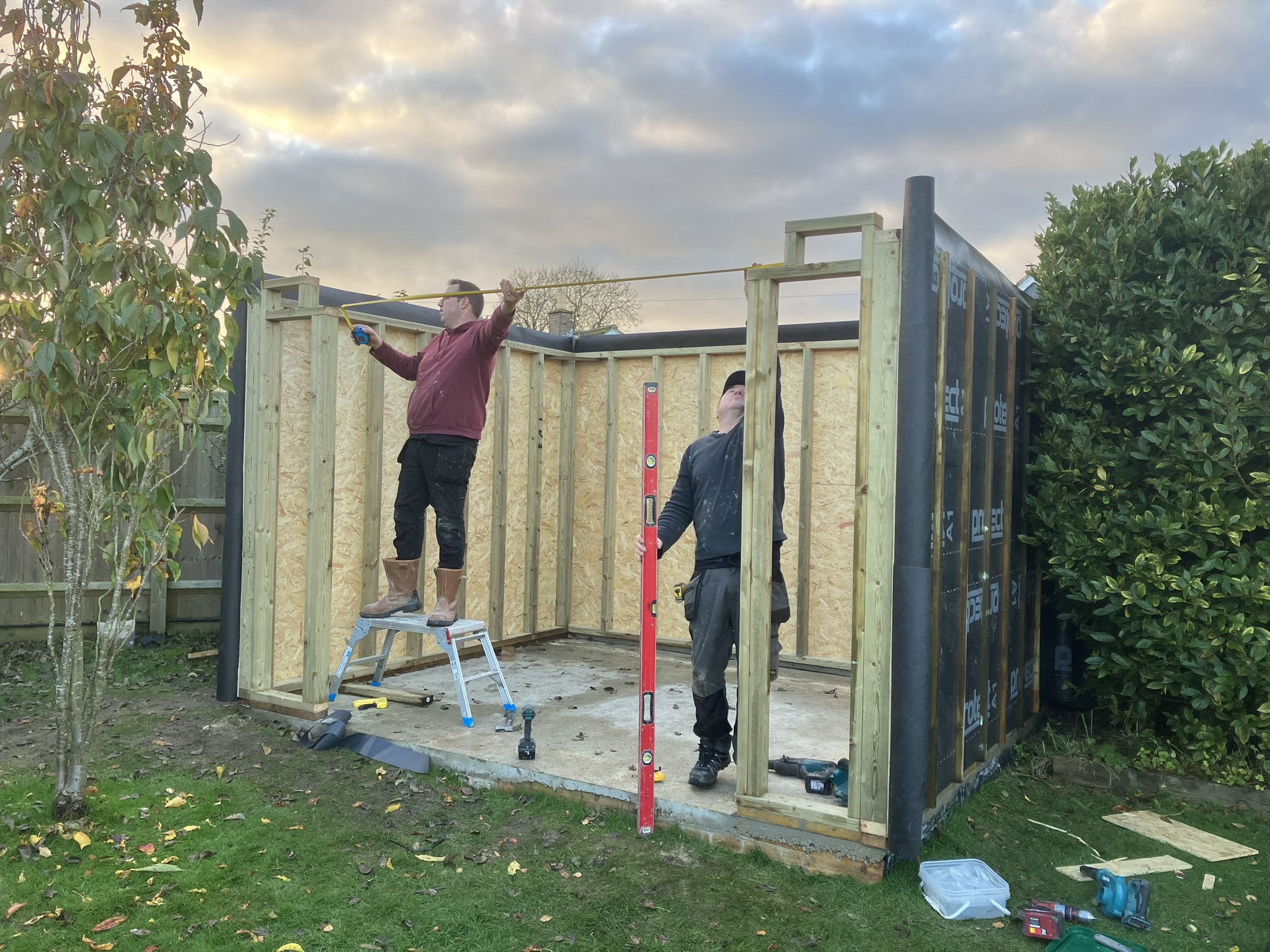 Workers building garden room